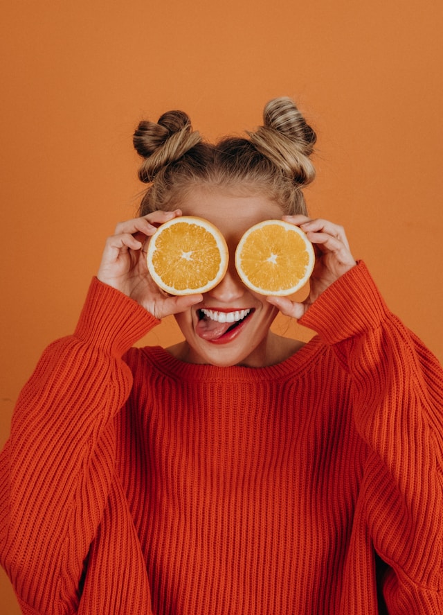 healthy woman holding organic fruit